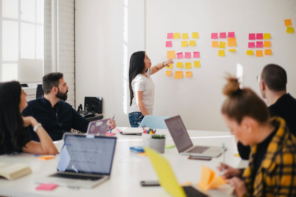 woman placing sticky notes on wall choosing paraeducator professional development