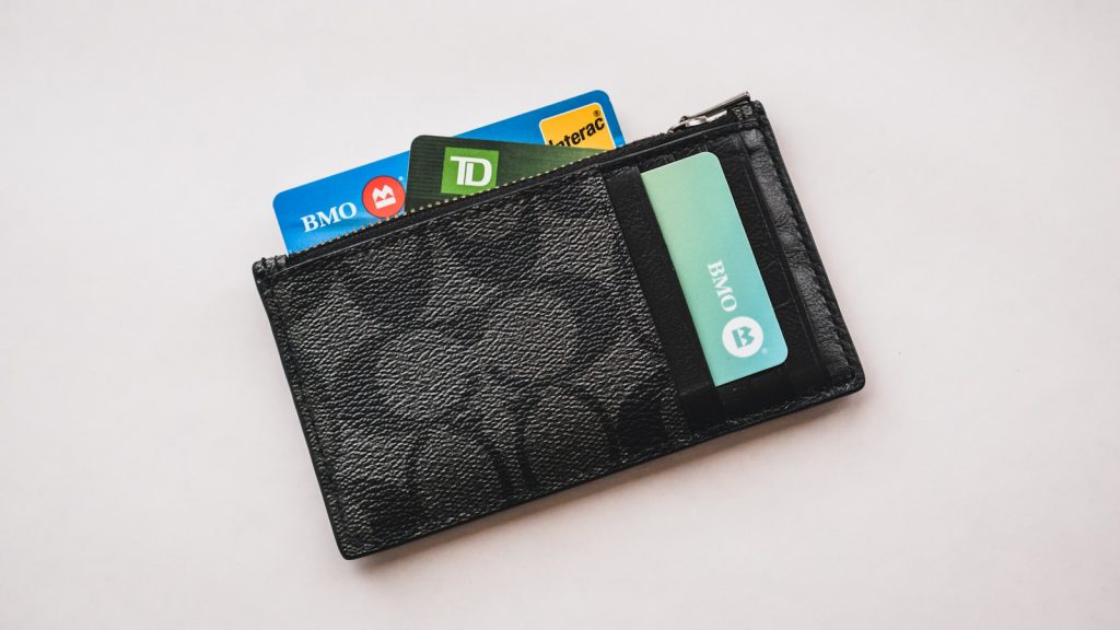 a wallet with credit cards sticking out of it representing taking over your credit card debt with a paraeducator budget